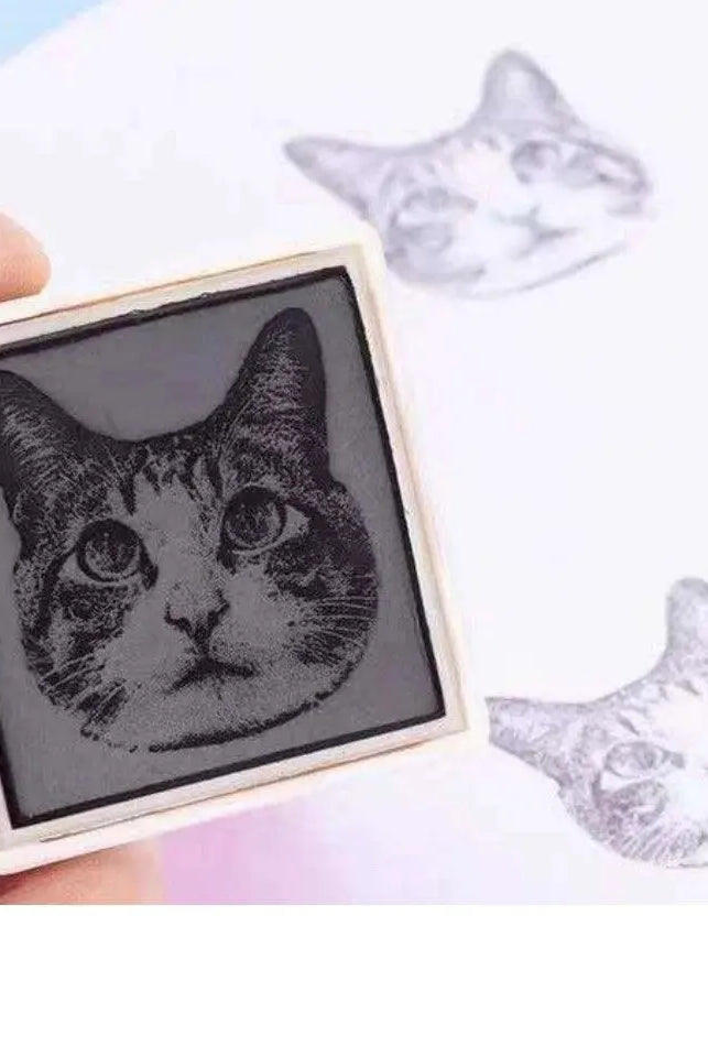 Enlarged bottom stamp part of the head of cat portrait and two prints beside showcasing accuracy