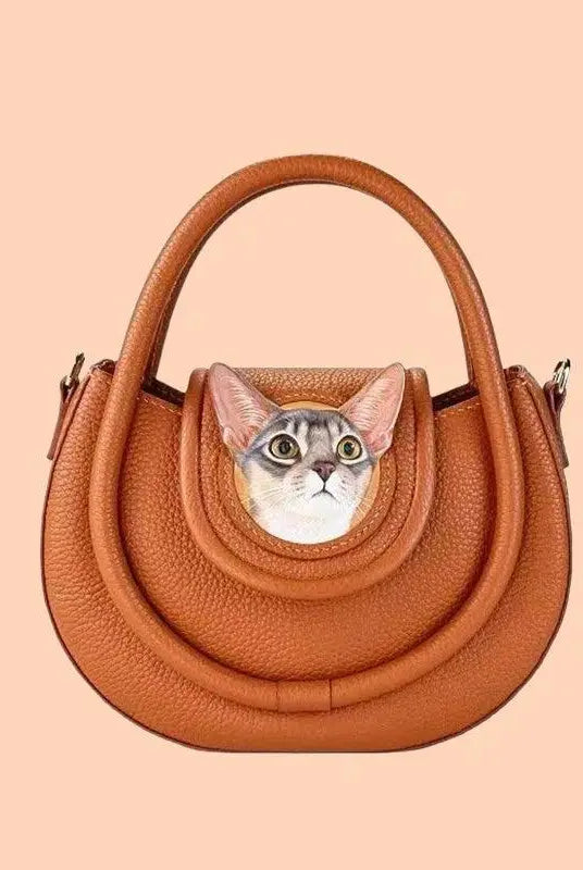 front view of a handmade handbag carved with cat