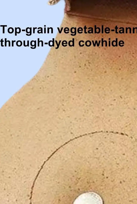 Close-up of natural grain texture and hand-burnished edges on full-grain leather pet saddle bag.