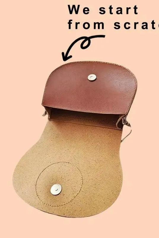 Side view of the custom pet saddle bag showing vegetable-tanned leather aging patina and reinforced