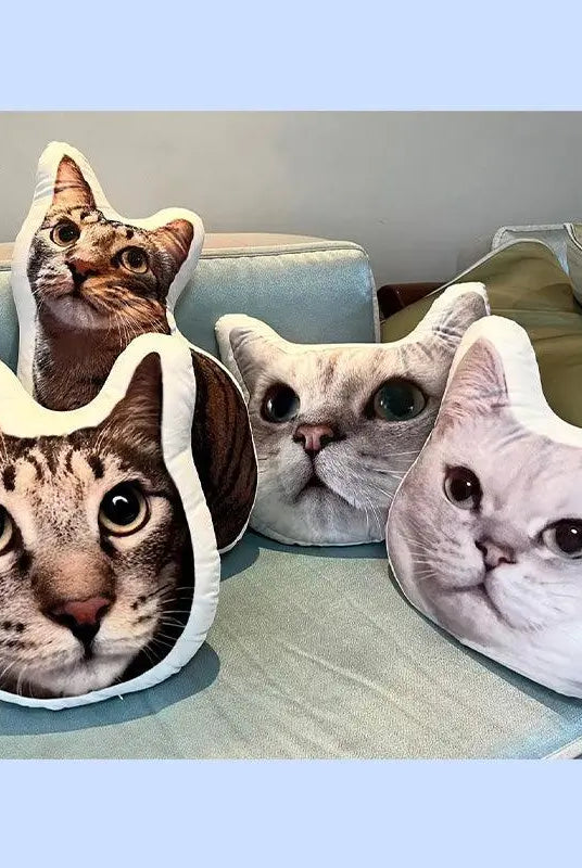 three cat head pillow and a full body cat pillow on the sofa