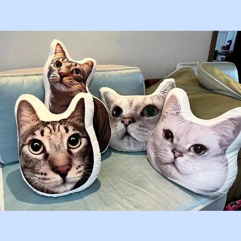 three cat head pillow and a full body cat pillow on the sofa