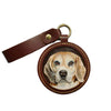 Close-up of 3D textured leather surface showing precise hand-made golden retriever portrait on custom pet keychain