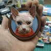 Leather keychain with a 3D-embossed face of a Sphynx cat