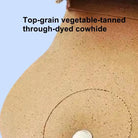 Close-up of natural grain texture and hand-burnished edges on full-grain leather pet saddle bag.