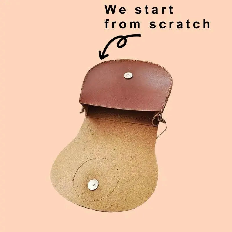 Side view of the custom pet saddle bag showing vegetable-tanned leather aging patina and reinforced 